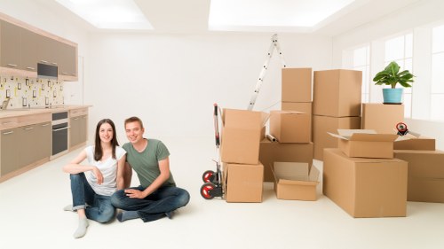 Moving day preparation with boxes, furniture protection, and transport in Surrey
